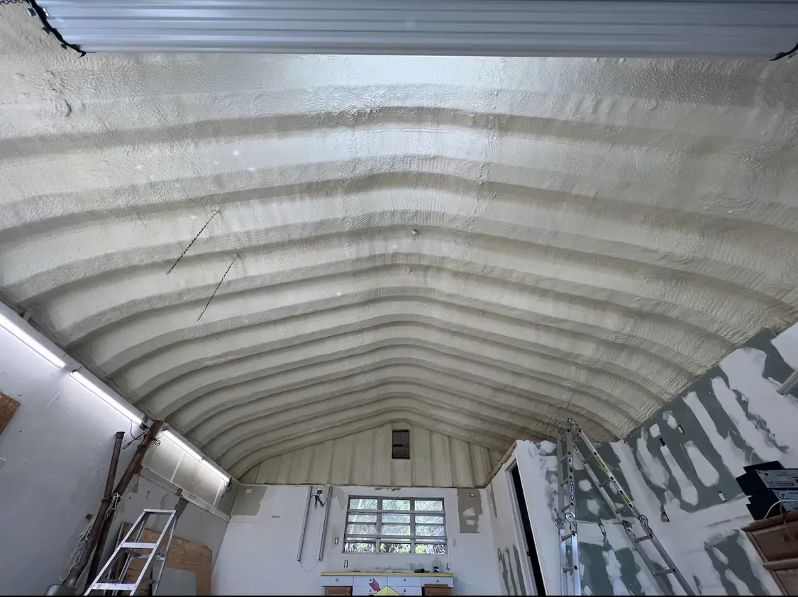 Spray polyurethane foam applied to the underside of a metal roof deck in Kronenwetter
